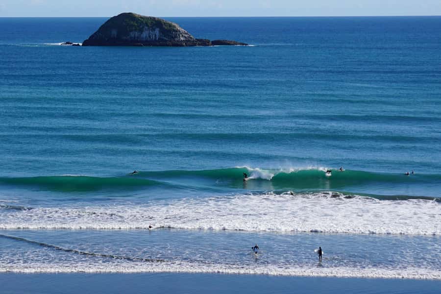 Auckland: Group Surfing Lesson with Muriwai Surf School - Instructor support that helps first-timers stand up