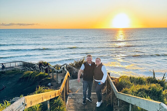 [PRIVATE] SUNSET. Wine. Hot Pool. Dinner - Muriwai Beach at sunset: black sand, sea spray, and photo light