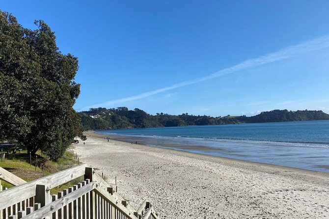 Waiheke Island Half Day Scenic Wine and Lunch - Onetangi Beach break: photos, trees, and a little island character